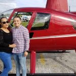 A couple taking a photo before going on their helicopter tour